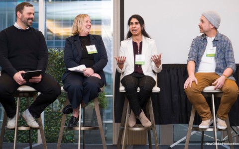a group of people sitting on stools