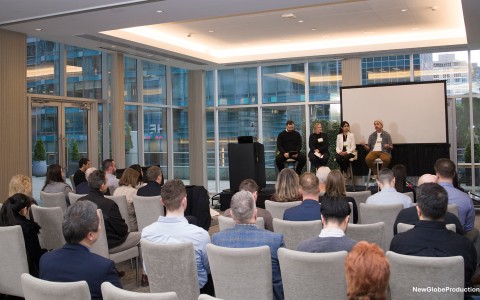 a group of people in a room with a screen and a screen
