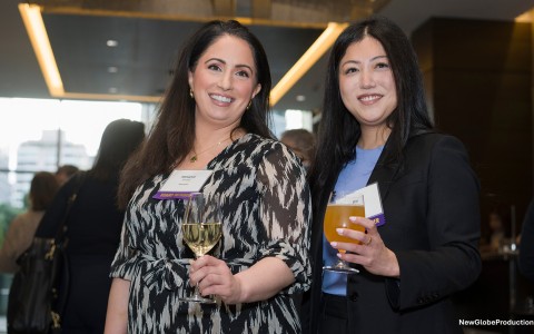 two women holding wine glasses