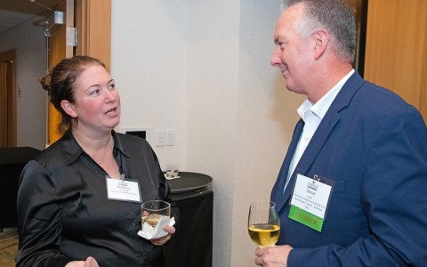 a man and woman talking at a business event