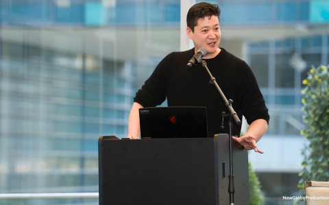 a man standing at a podium with a microphone