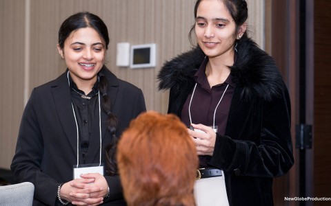 a group of women standing in front of a woman