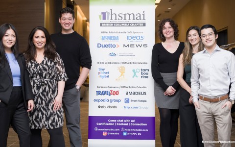 a group of people standing next to a sign