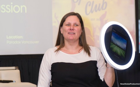 a woman holding up a circle