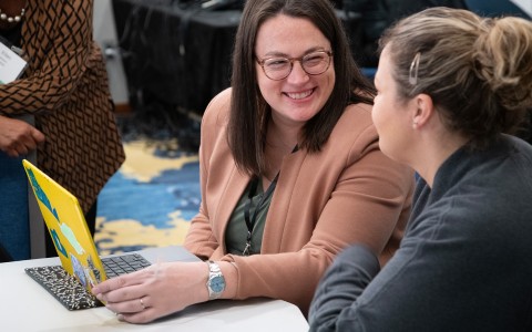 a woman smiling at another woman