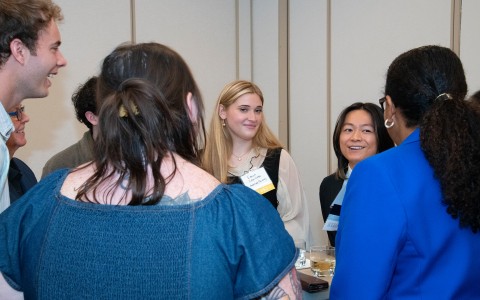 a group of women standing around a table