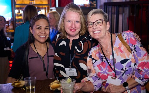 a group of women smiling at camera