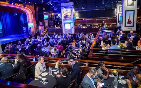 a group of people sitting at tables in a restaurant