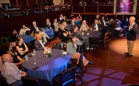 a group of people sitting at tables
