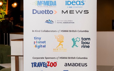 a white sign with many logos