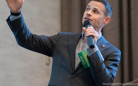 a man in a suit holding a microphone