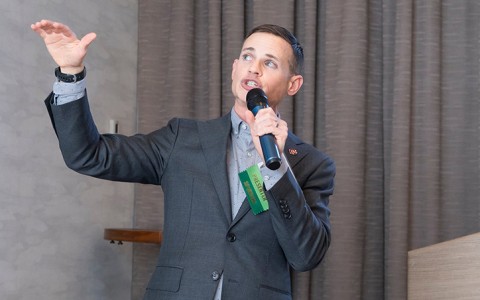 a man in a suit holding a microphone