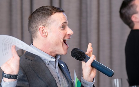 a man holding a microphone and screaming