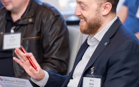a man holding a pen and looking at a paper
