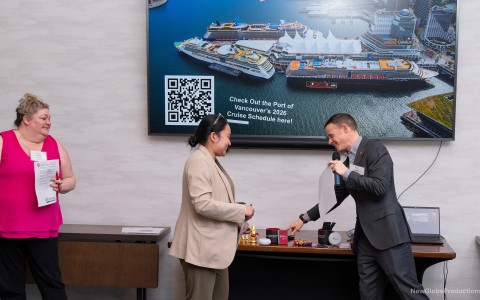 a man and woman talking in front of a screen