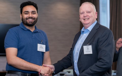 a man shaking hands with another man