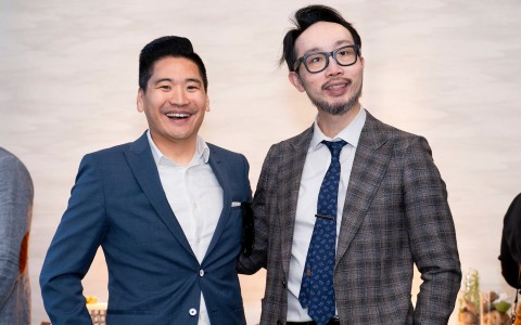 two men in suits smiling