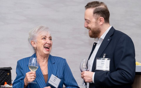a man and woman holding wine glasses