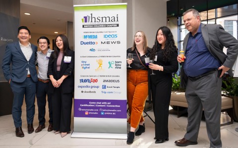 a group of people standing next to a sign