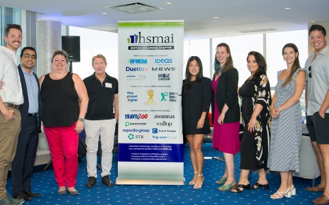 a group of people standing in front of a sign