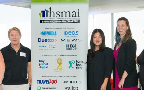 a group of people standing next to a sign