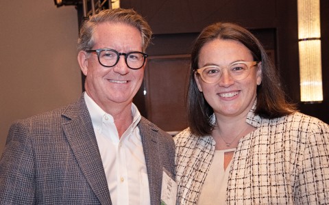 a man and woman smiling at the camera