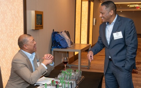 a man in a suit holding hands with another man in a suit