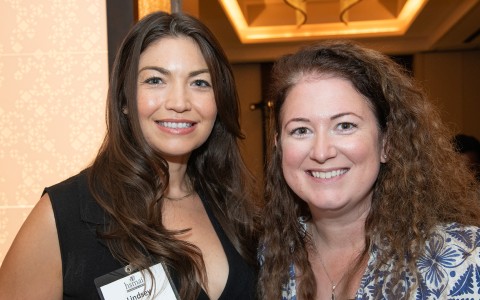 two women smiling at the camera