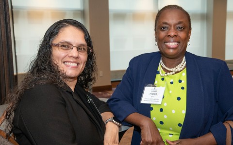 two women smiling at the camera