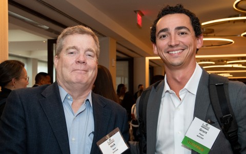 two men smiling at the camera