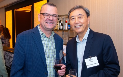 two men holding wine glasses