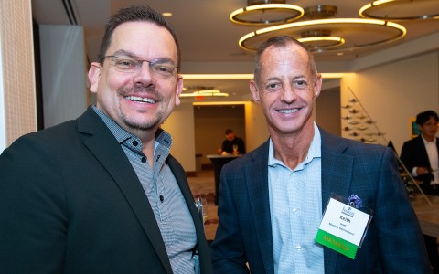 two men smiling at the camera