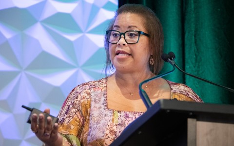 a woman standing at a podium
