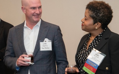 a man and woman holding drinks