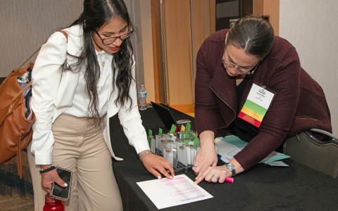a woman pointing at a piece of paper