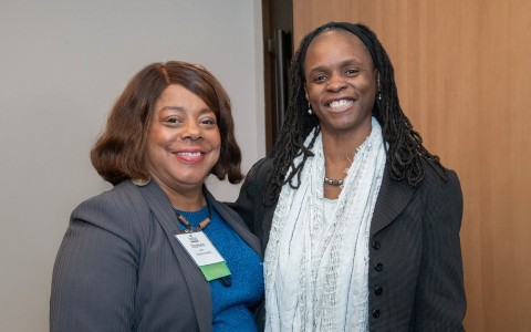 two women smiling at the camera
