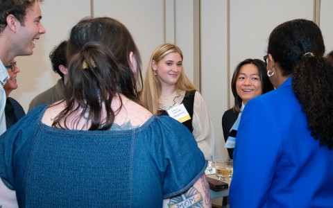 a group of women standing around a table