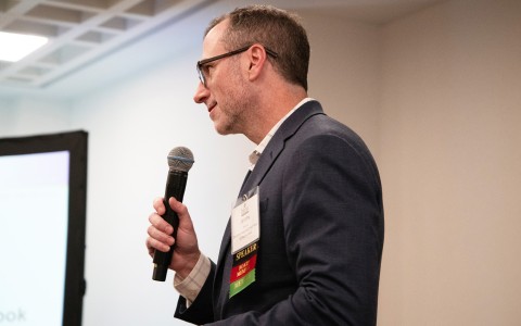 a man in a suit holding a microphone