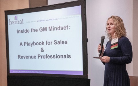 a woman standing in front of a screen