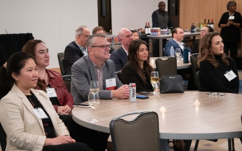 a group of people sitting at a round table