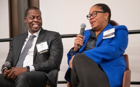 a man and woman sitting in chairs with microphones