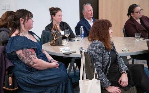 a group of people sitting at a round table