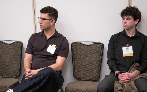 a group of men sitting in chairs