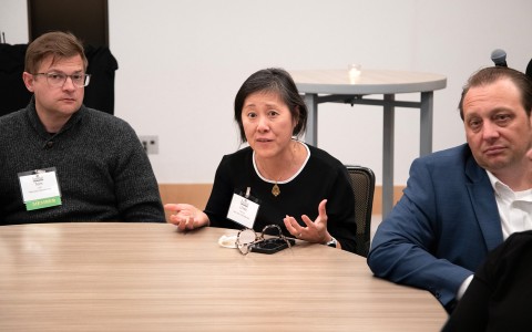 a woman sitting at a table with a group of people