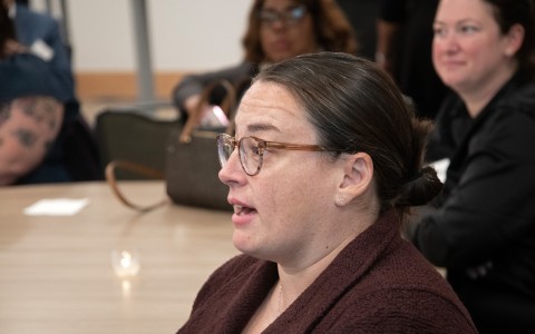 a woman wearing glasses and a brown robe