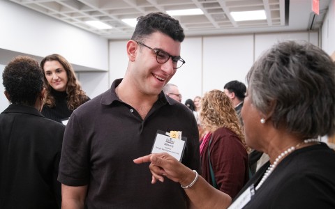 a man pointing at a name tag