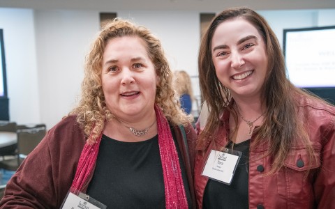 two women smiling at camera