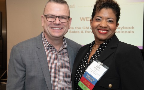 a man and woman smiling at the camera
