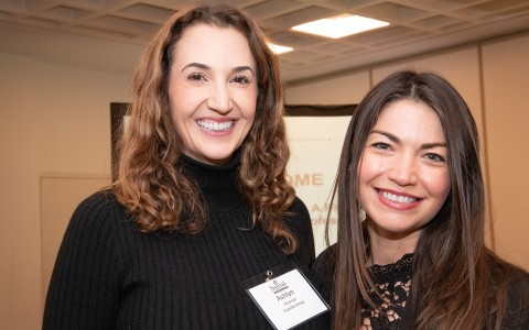 a couple of women smiling at the camera
