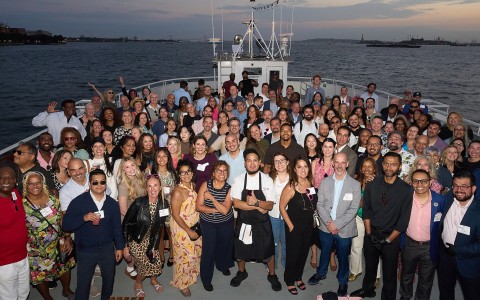 a group of people posing for a photo on a boat